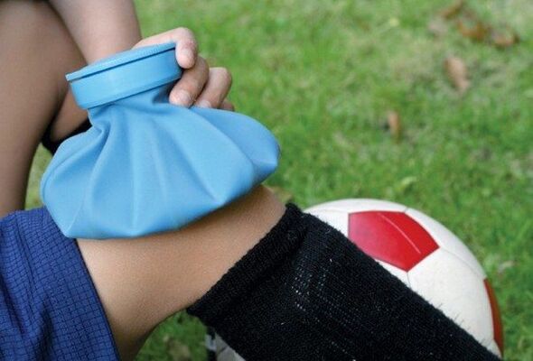 Applying a cold compress for a knee injury